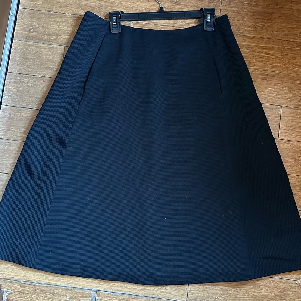 A-line Barneys New Yorker black skirt.  Lined, with two angled pockets.